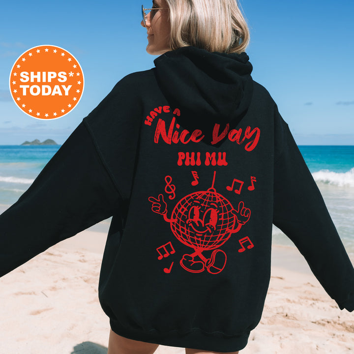 a woman in a black hoodie is walking on the beach