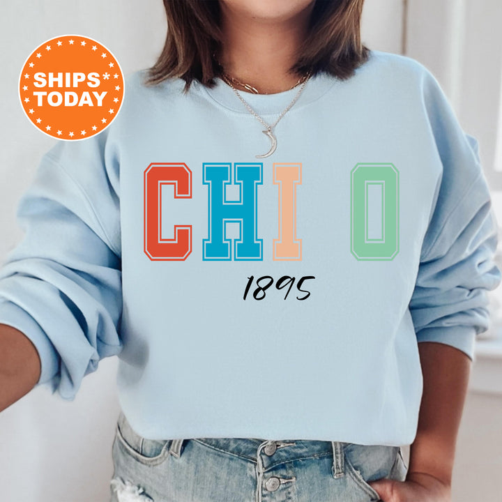 a woman wearing a blue sweatshirt with the word chio printed on it