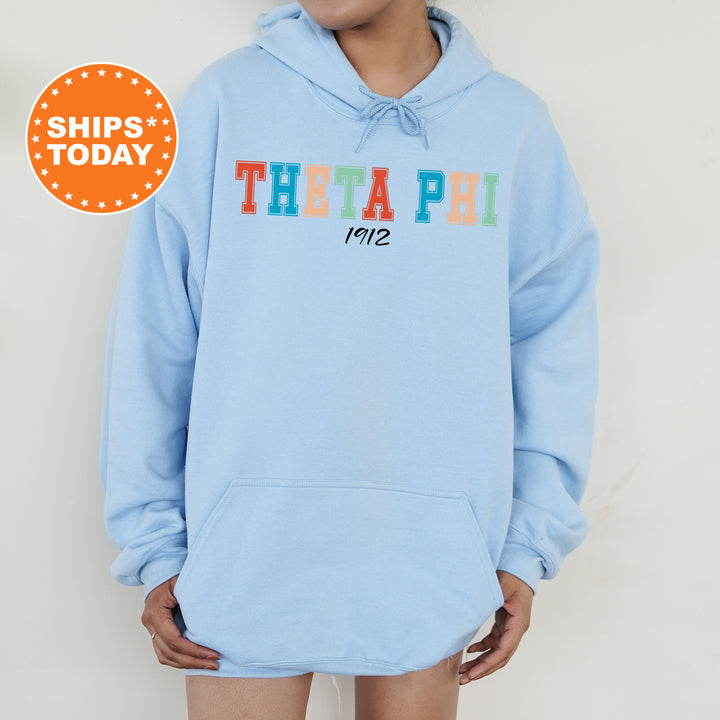 a woman wearing a blue hoodie with the word thea pi on it