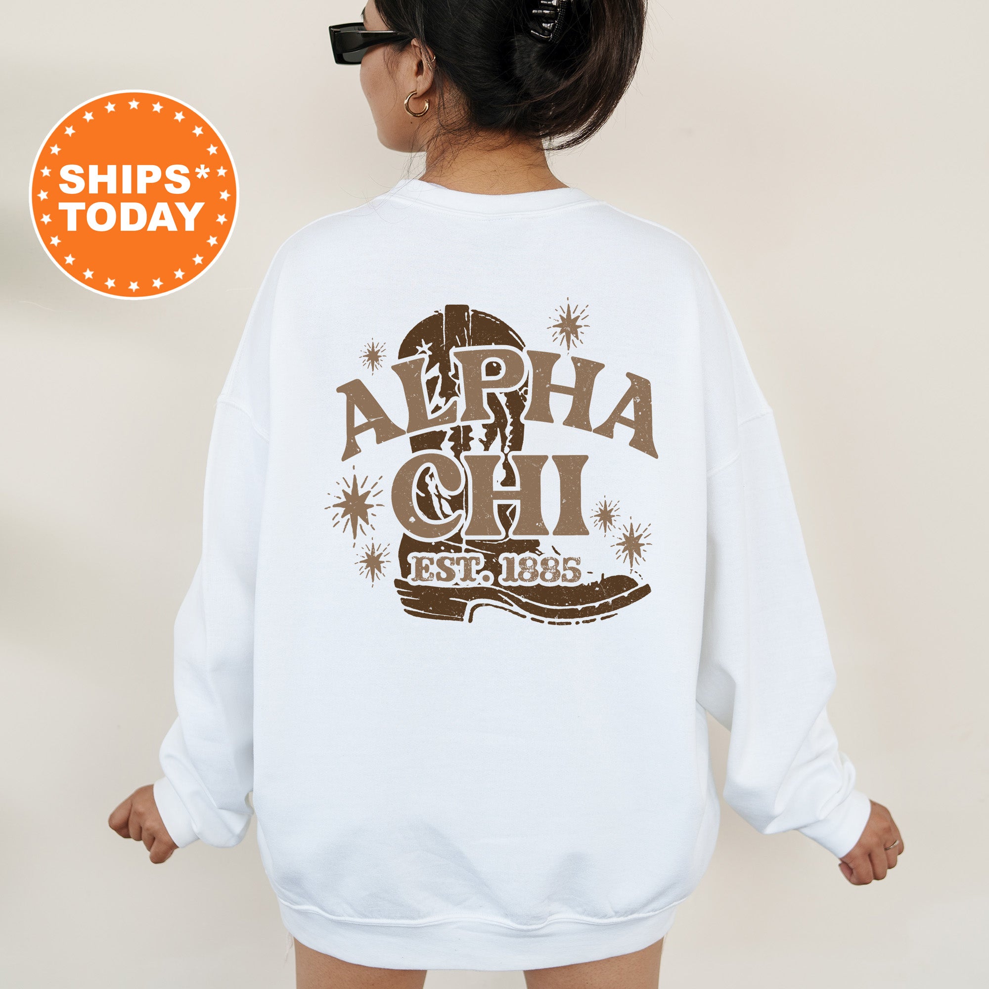 a woman wearing a white sweatshirt with a brown graphic on it