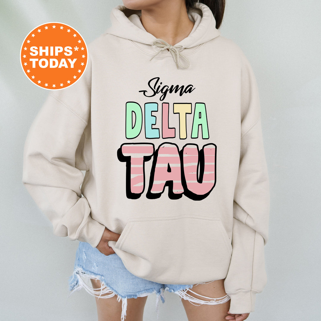 a woman wearing a sweatshirt with the words delta tau on it