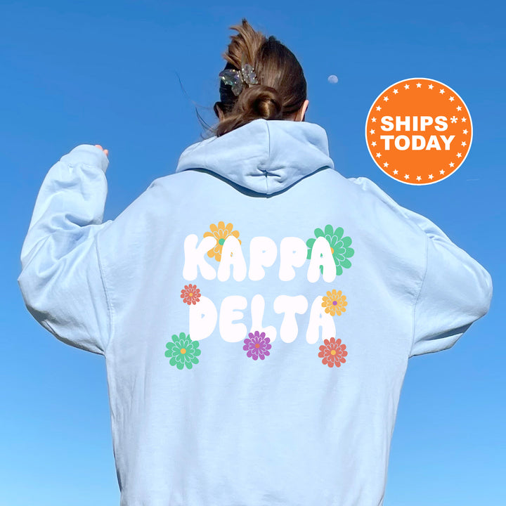 a woman wearing a hoodie with the words kapea delta printed on it