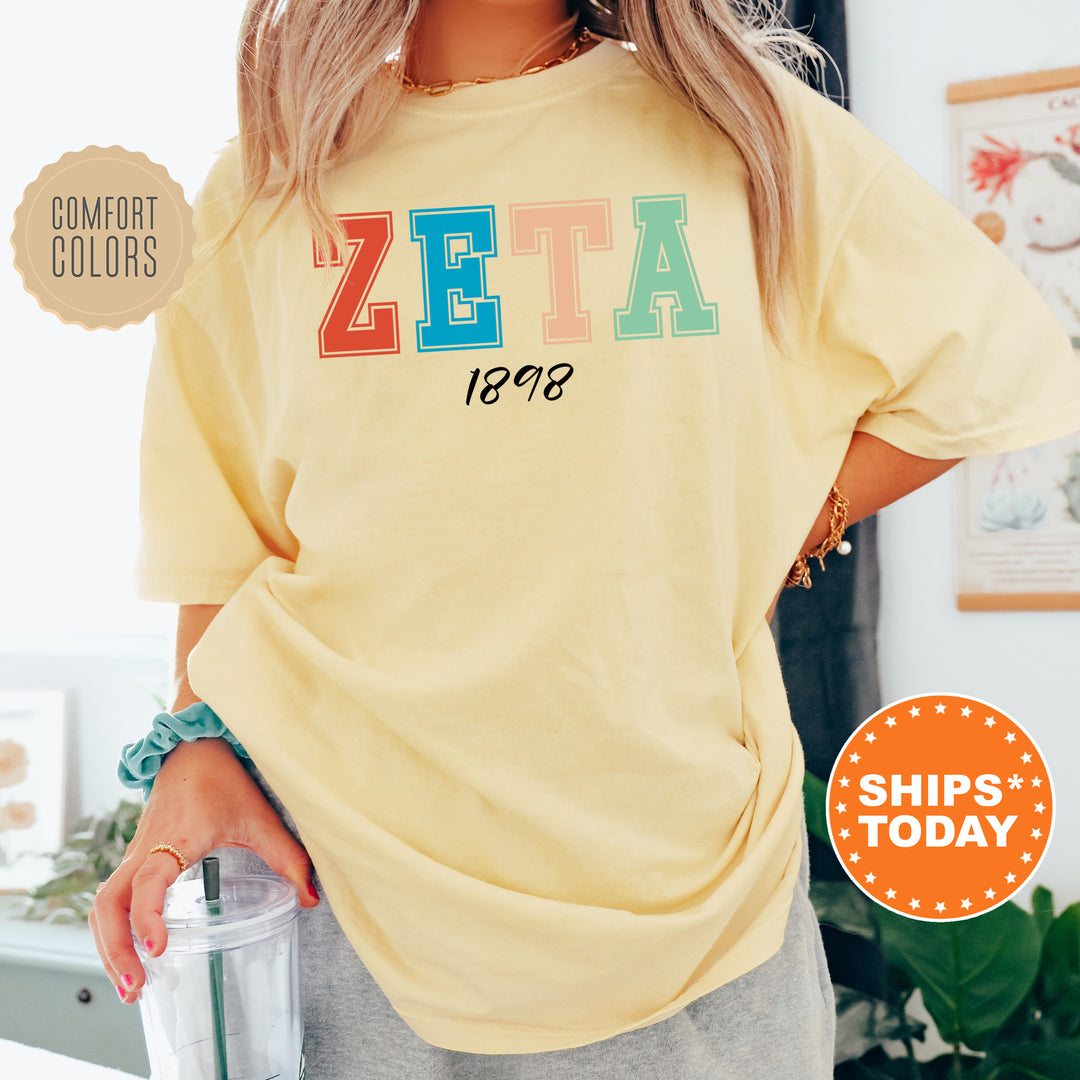 a woman wearing a yellow shirt with the word zeia printed on it