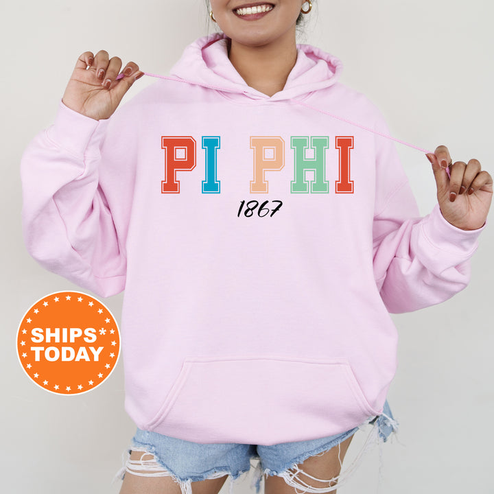a woman wearing a pink hoodie with the word pi phi on it
