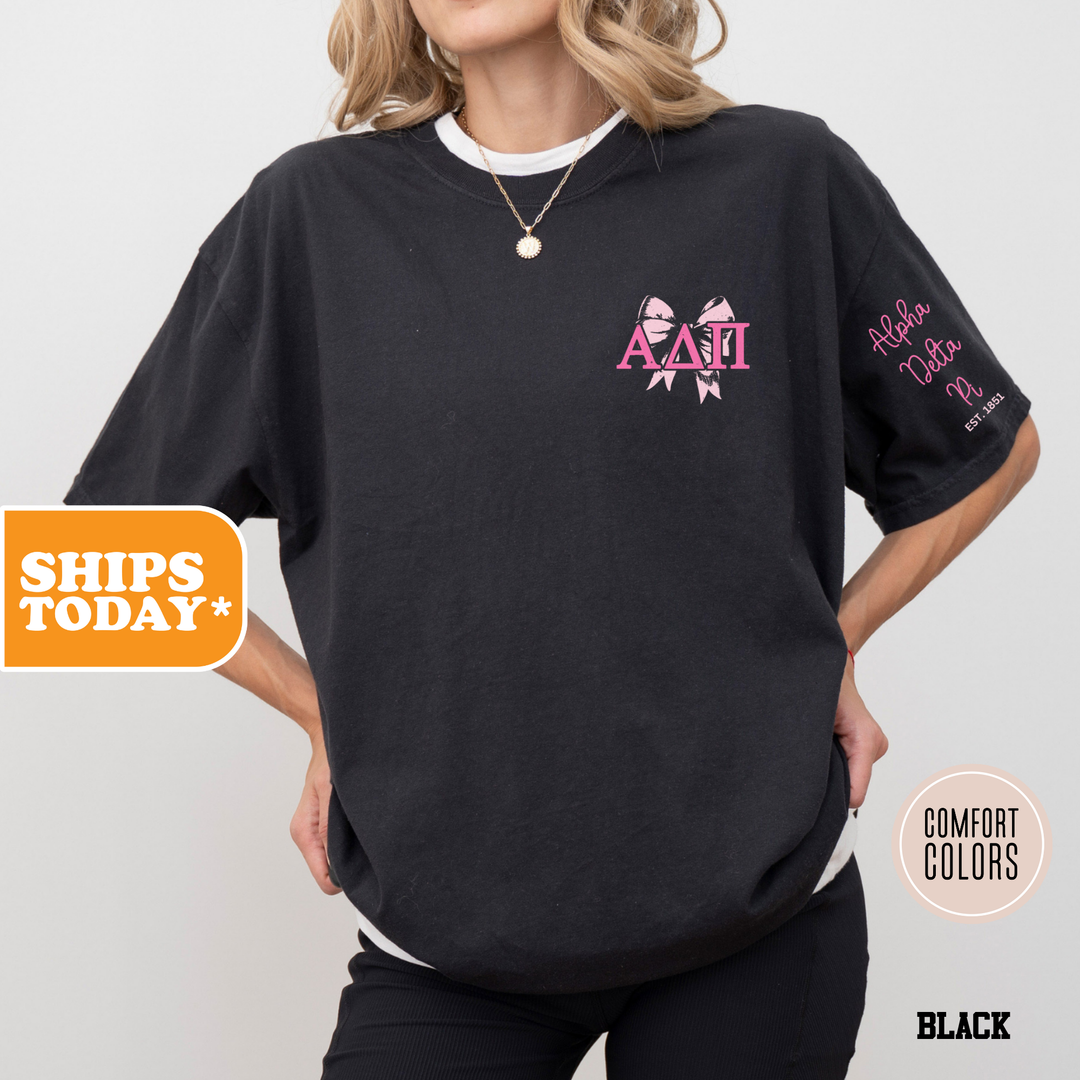 a woman wearing a black shirt with pink letters on it