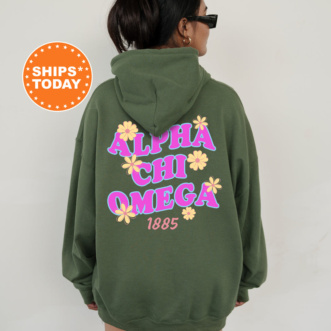 A person wearing a green hoodie with the text "ALPA CHI OMEGA 1885" printed on it.