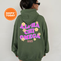 A person wearing a green hoodie with the text 
