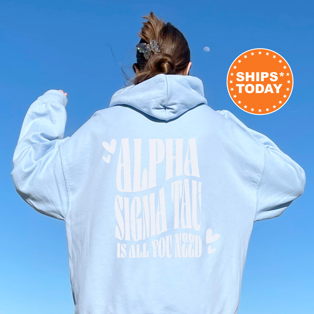 a woman wearing a white hoodie with the words alpha and shema