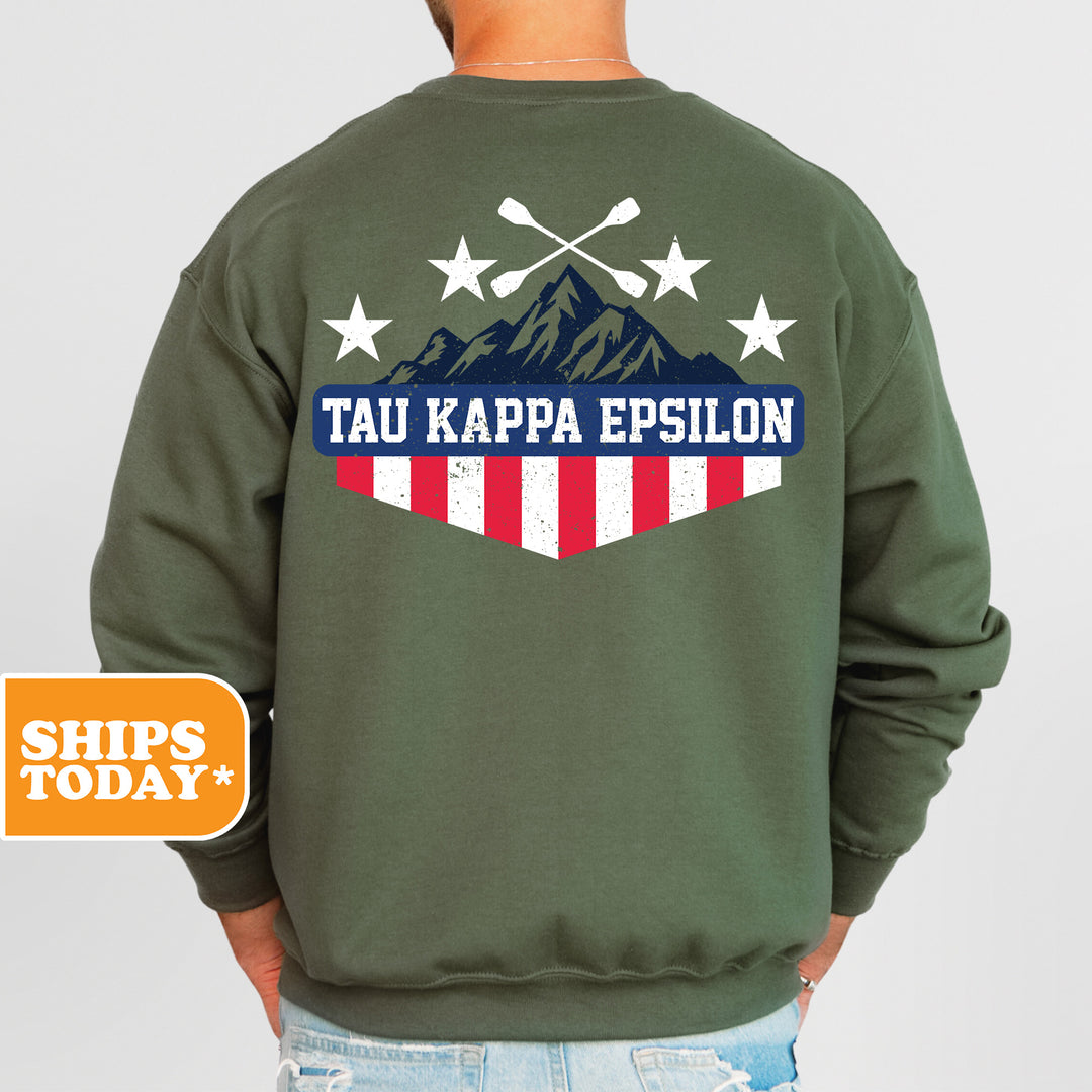 a man wearing a green sweatshirt with the words tau kappa epsilon