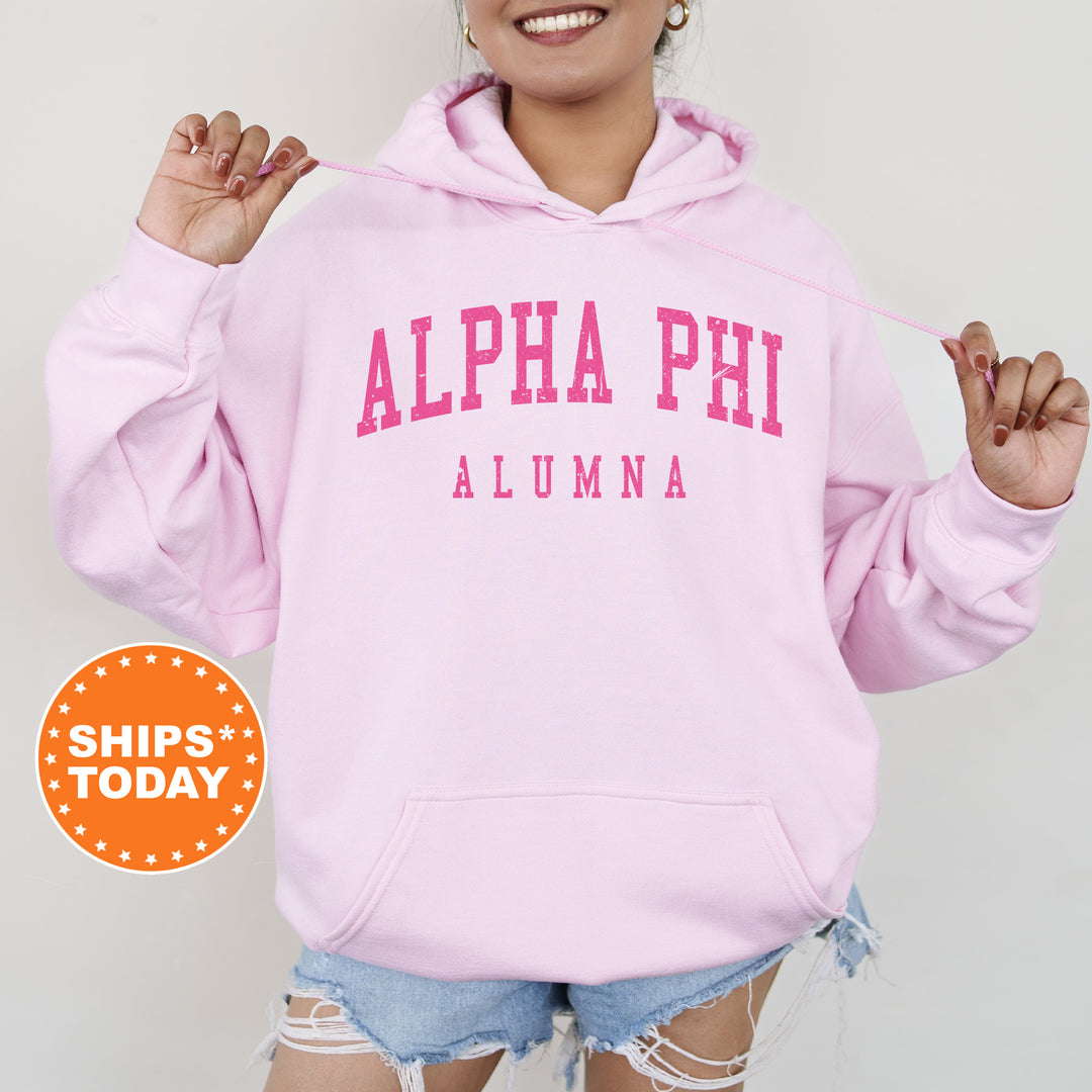 a woman wearing a pink hoodie and ripped shorts