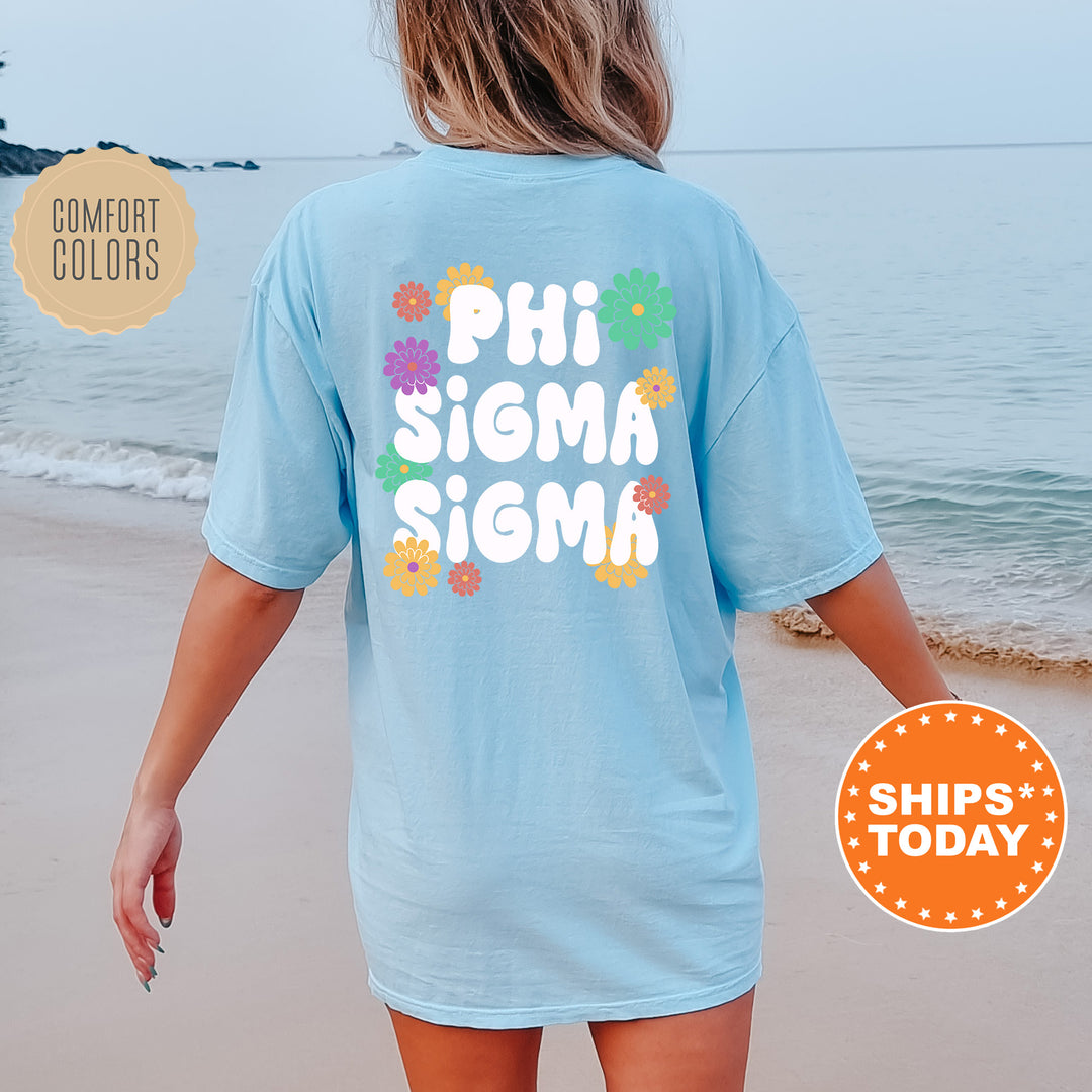 a woman walking on the beach wearing a shirt that says phi sigma si