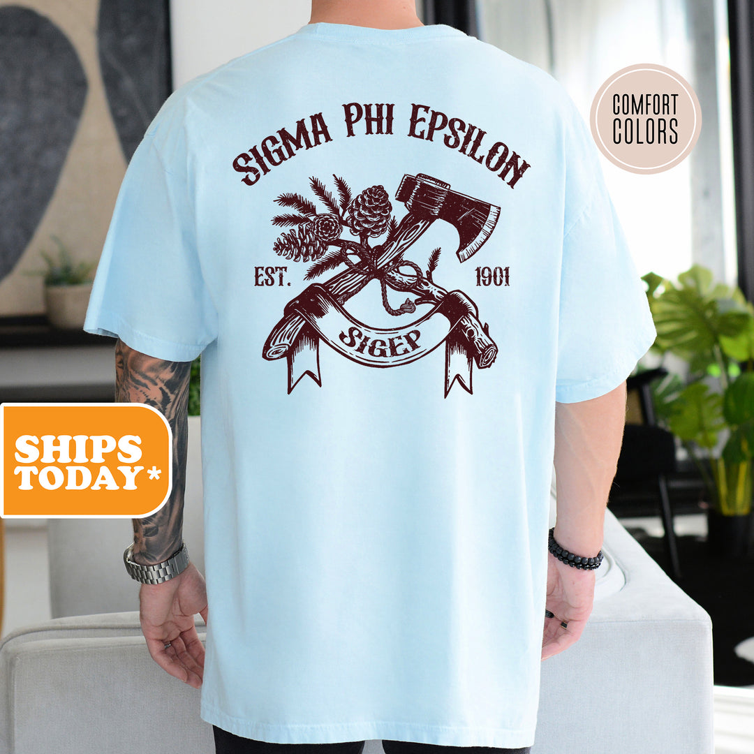 a man wearing a blue shirt with an image of a hammer and a pineapple