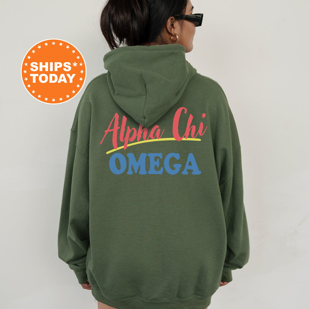 A person wearing a green hoodie with the text "Alpha Chi Omega" printed on it.