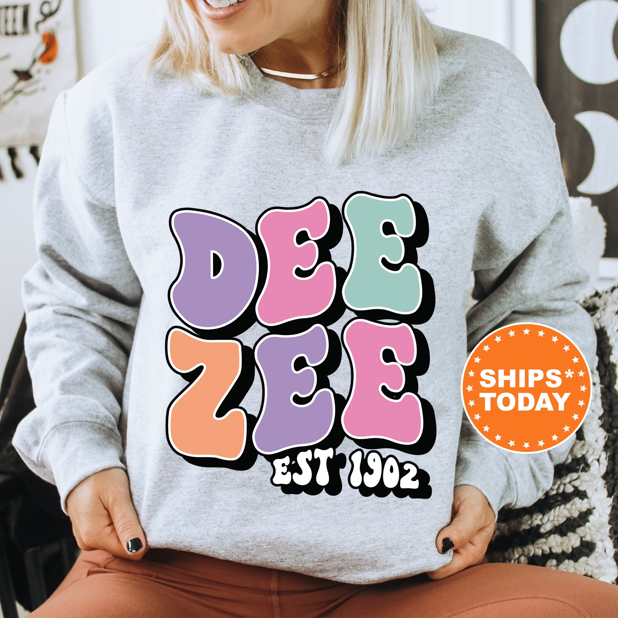 a woman sitting on a chair wearing a sweatshirt
