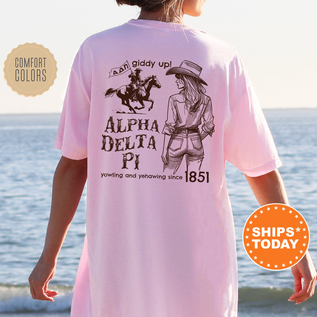 a woman wearing a pink shirt with an image of a horse and rider on it