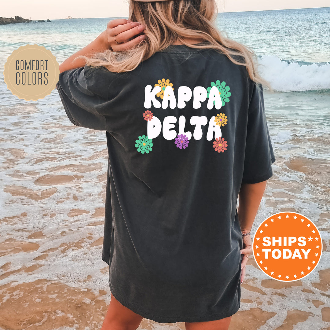 a woman standing on a beach wearing a shirt that says kappa delta