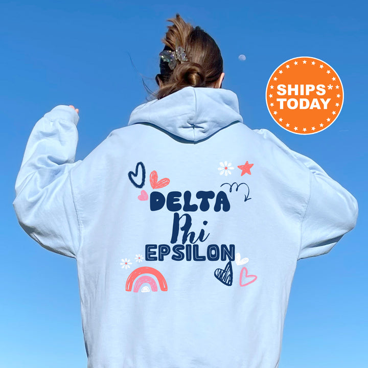 a woman wearing a white hoodie with the words delta phi epsilon on