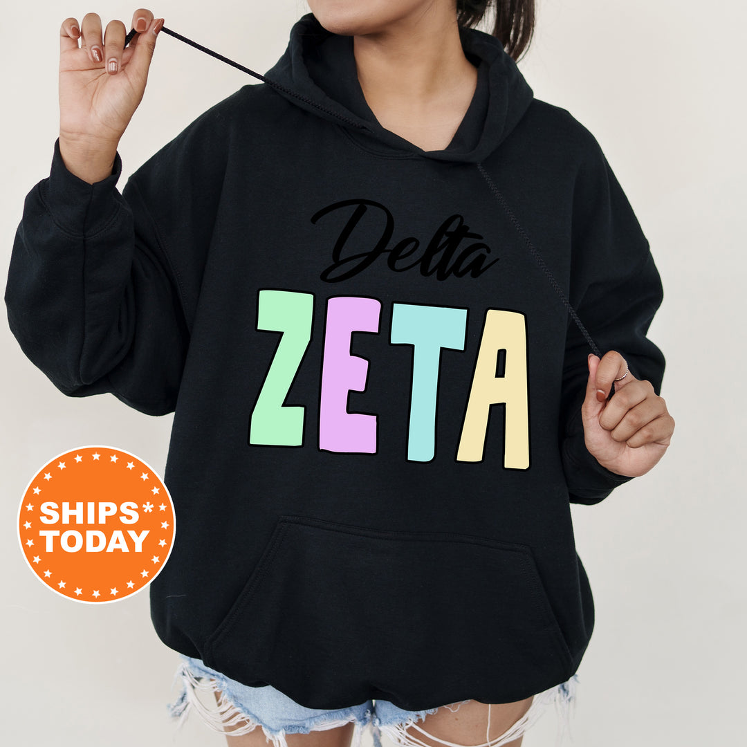 a woman wearing a black delta hoodie with the word delta on it