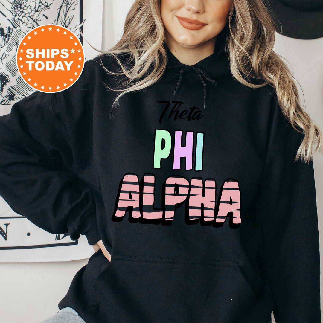 a woman wearing a black hoodie with the words phi alpa on it