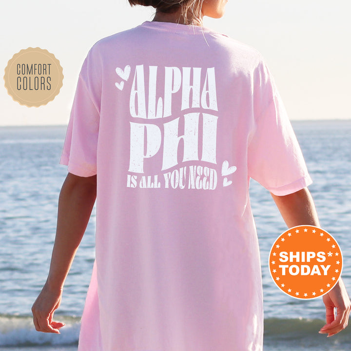 a woman wearing a pink shirt that says,'alpha phi is all you