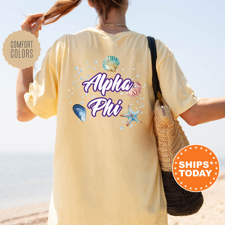 a woman is walking on the beach with her back to the camera