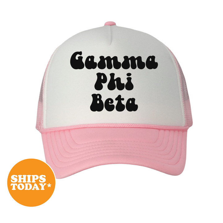 A white and pink baseball cap with the text "Gamma Phi Beta" printed on it.