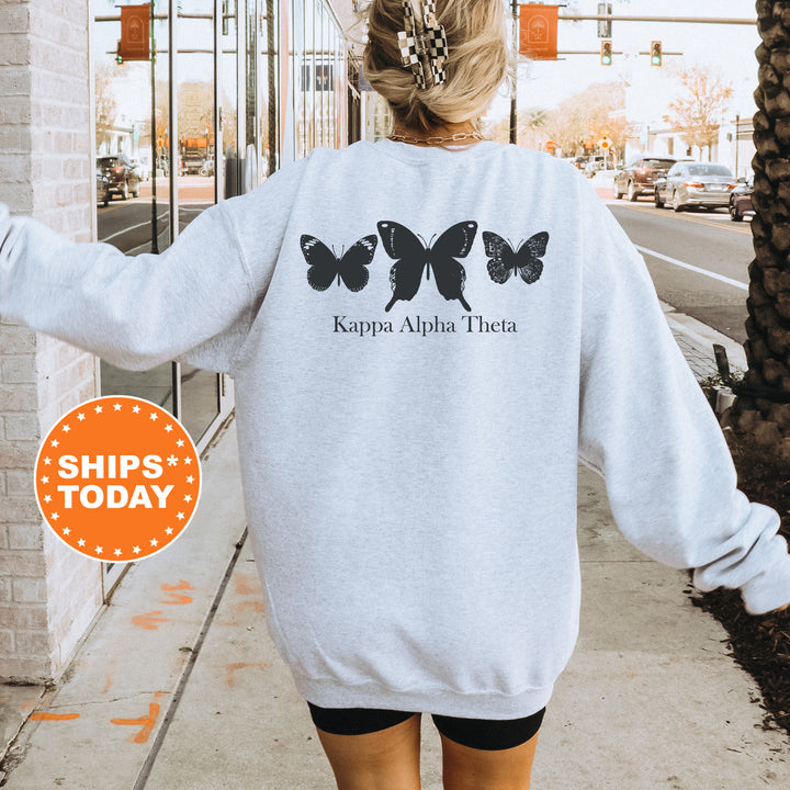 a woman walking down a sidewalk wearing a sweatshirt