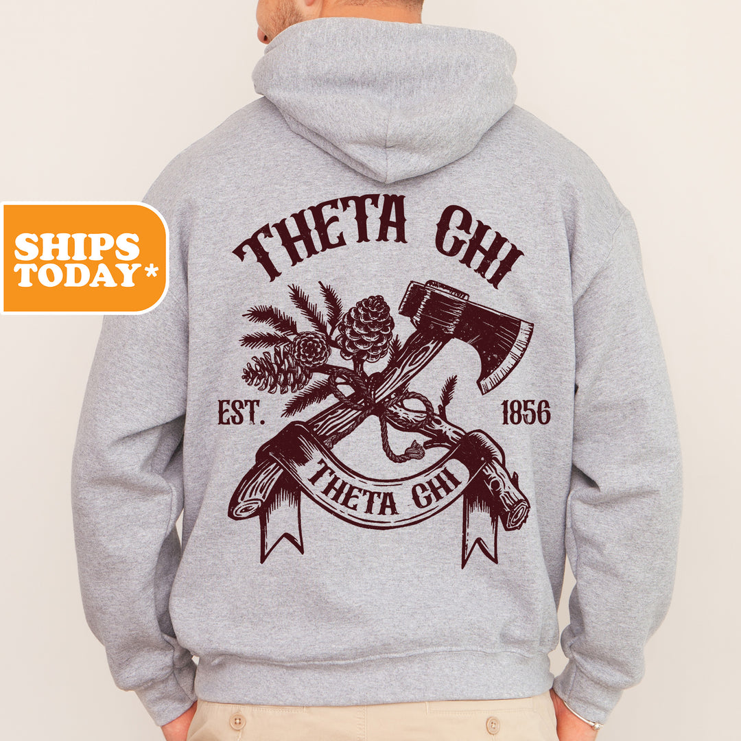 a man wearing a hoodie with a hammer and pine cone on it
