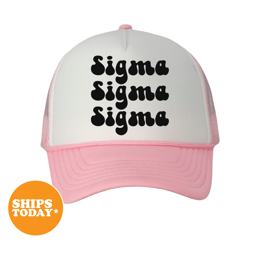 A white and pink baseball cap with the text "Sigma Sigma Sigma" printed on it.