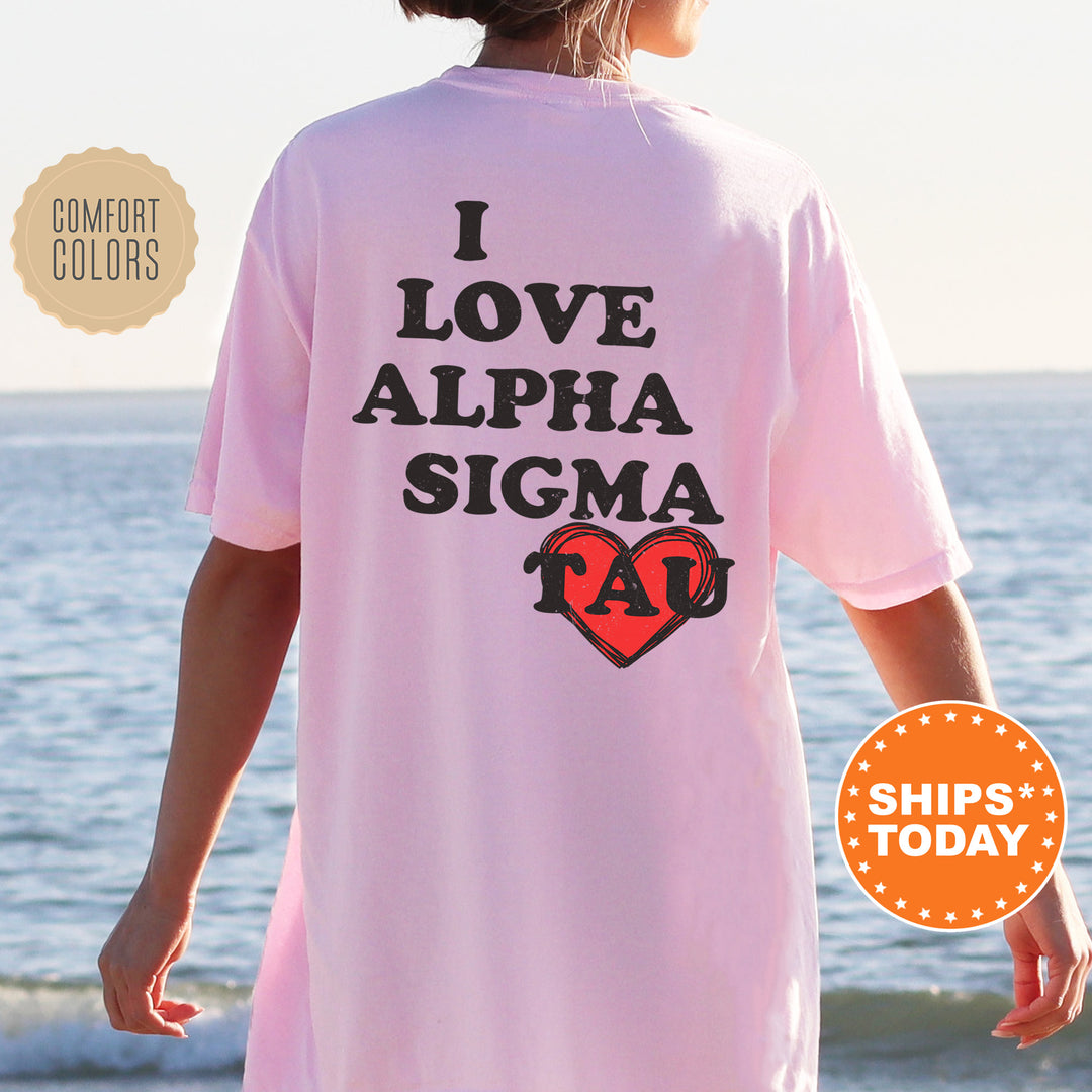 a woman standing on a beach wearing a pink shirt