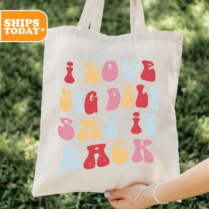 a person holding a tote bag with a design on it