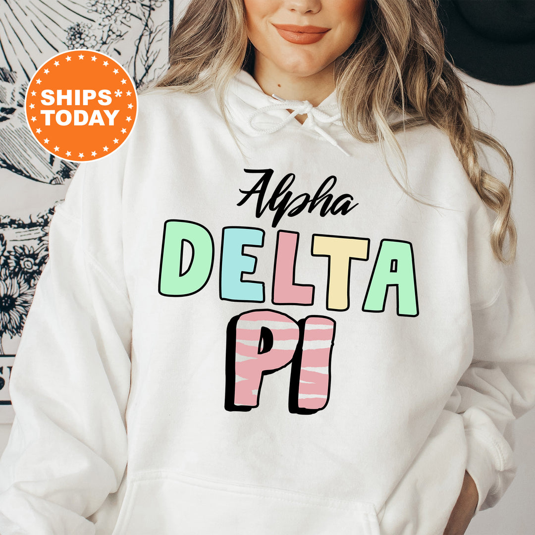 a woman wearing a white hoodie with the words delta pi on it