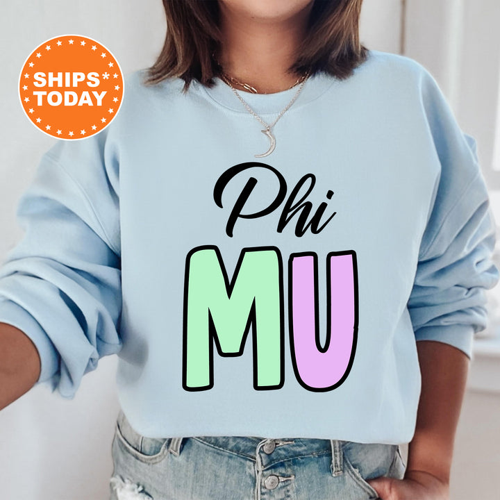 a woman wearing a sweatshirt that says phi mu