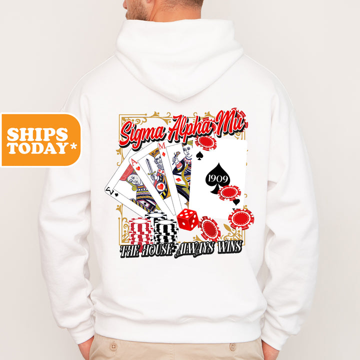 a man wearing a white hoodie with a picture of playing cards on it