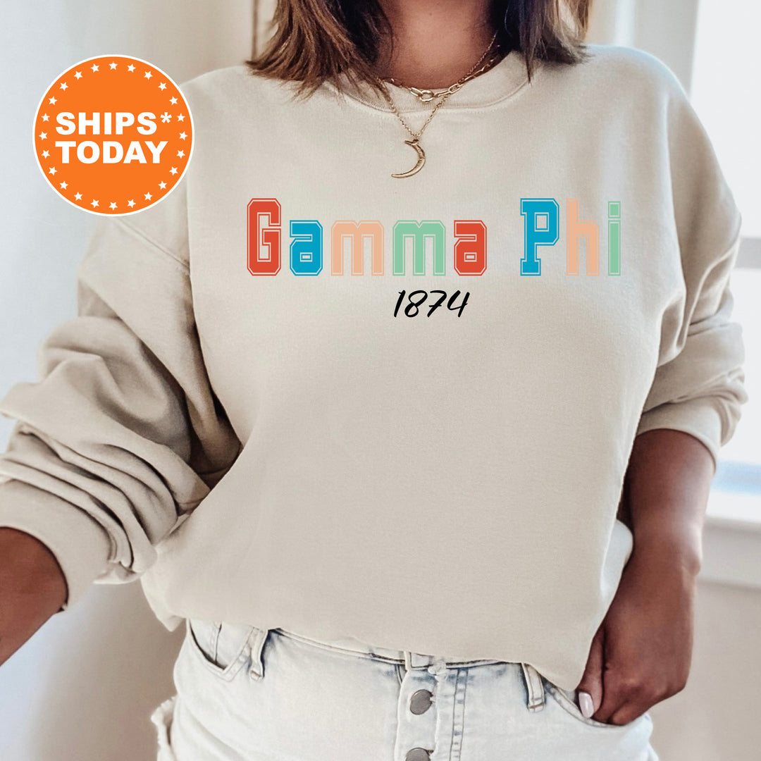 a woman wearing a sweatshirt with the words gama phi printed on it
