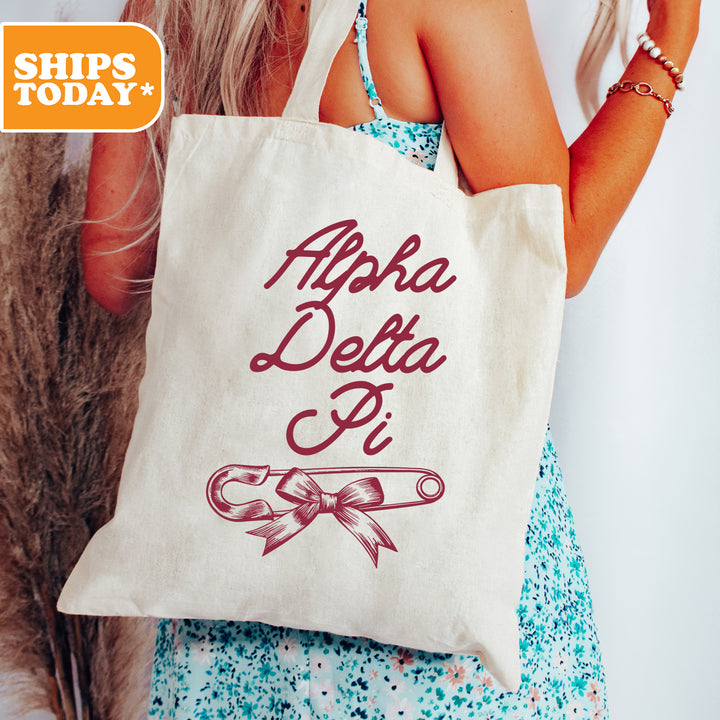 a woman holding a bag with the words aphra delta on it