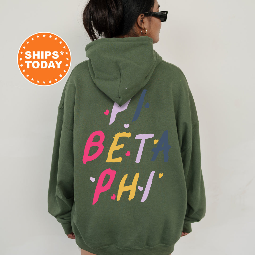 a woman wearing a green hoodie with the words beta phi printed on it