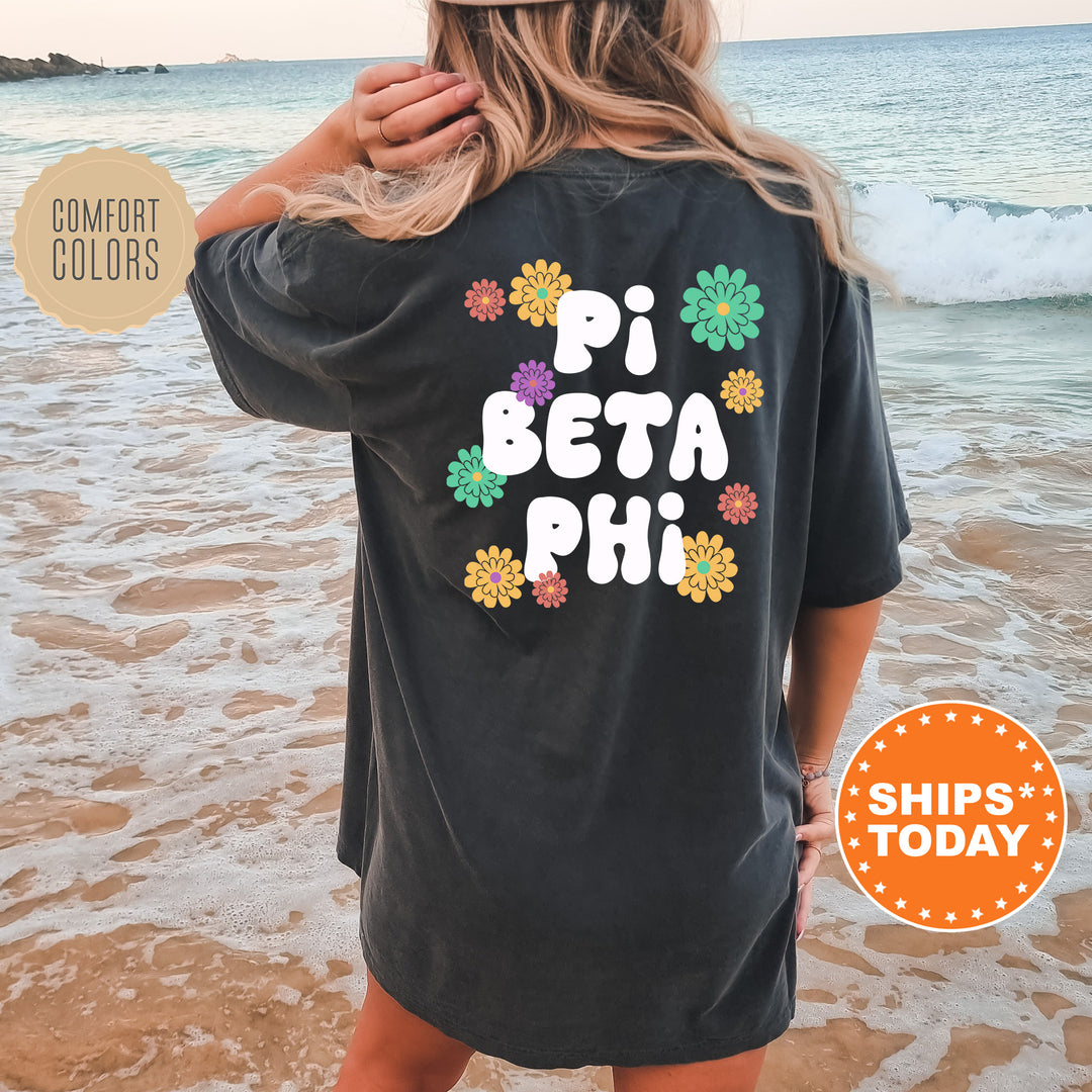 a woman standing on a beach wearing a t - shirt that says pi beta