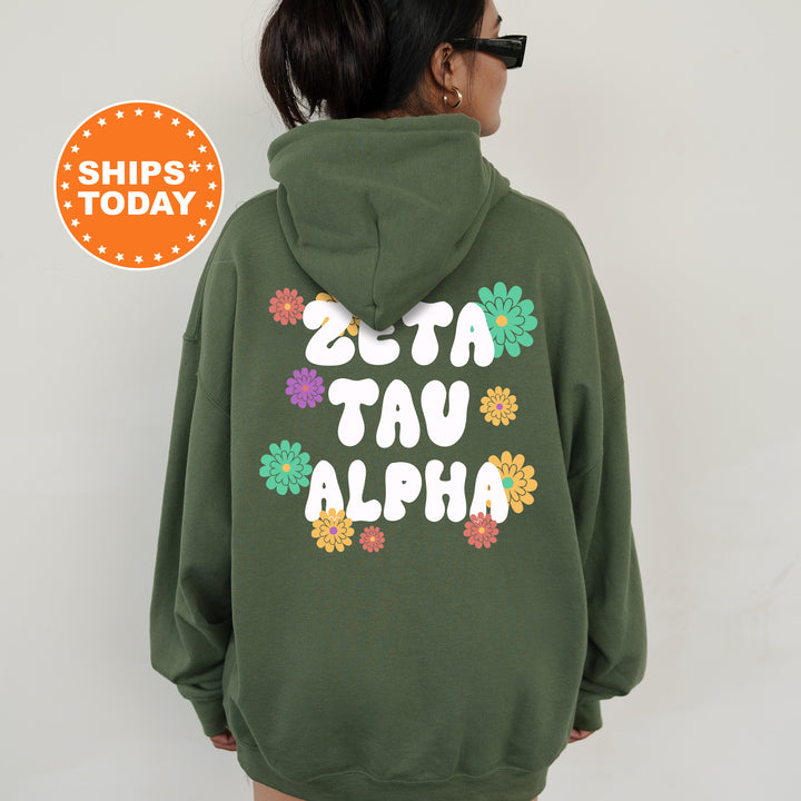 a woman wearing a green hoodie with flowers on it