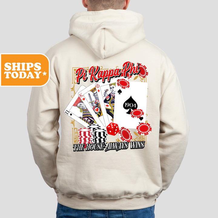 a man wearing a white hoodie with a picture of playing cards on it