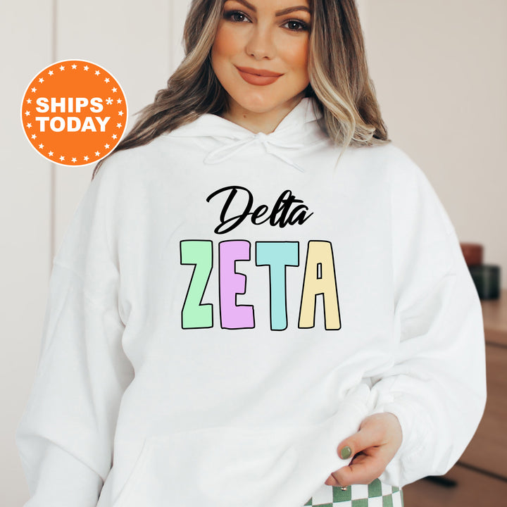 a woman wearing a white hoodie that says delta zeta