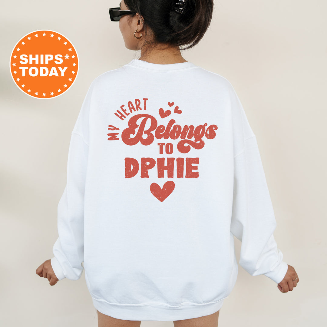 a woman wearing a white sweatshirt with the words heart belongs to phie on it