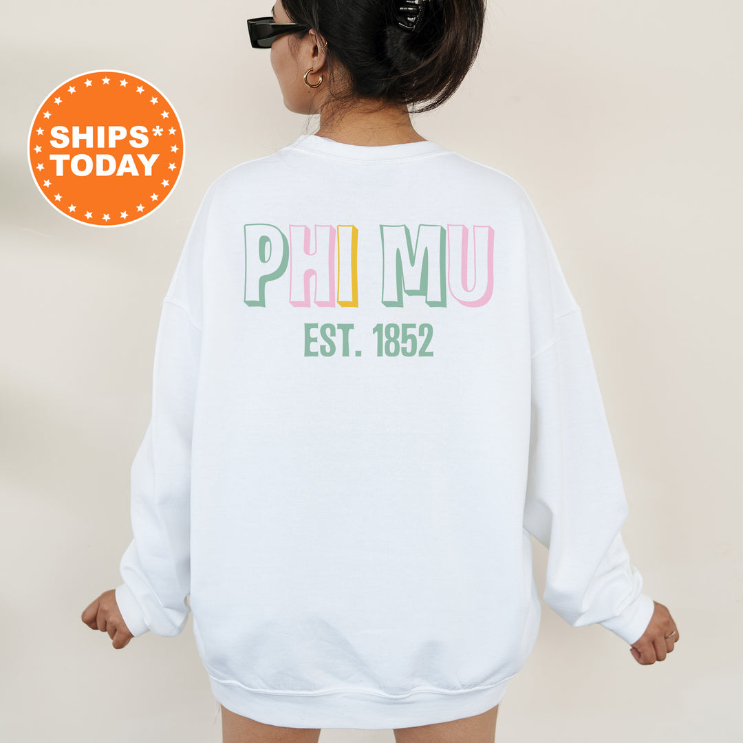 a woman wearing a white sweatshirt with the words phimu est 1932 printed on it