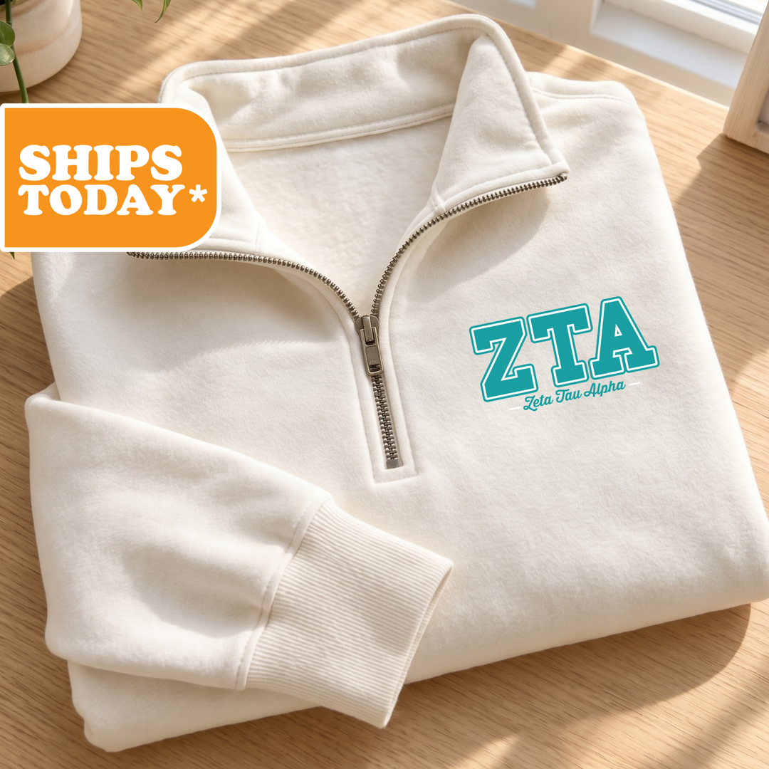 A white zip-up jacket with the text "ZTA" printed on it, placed on a wooden surface.