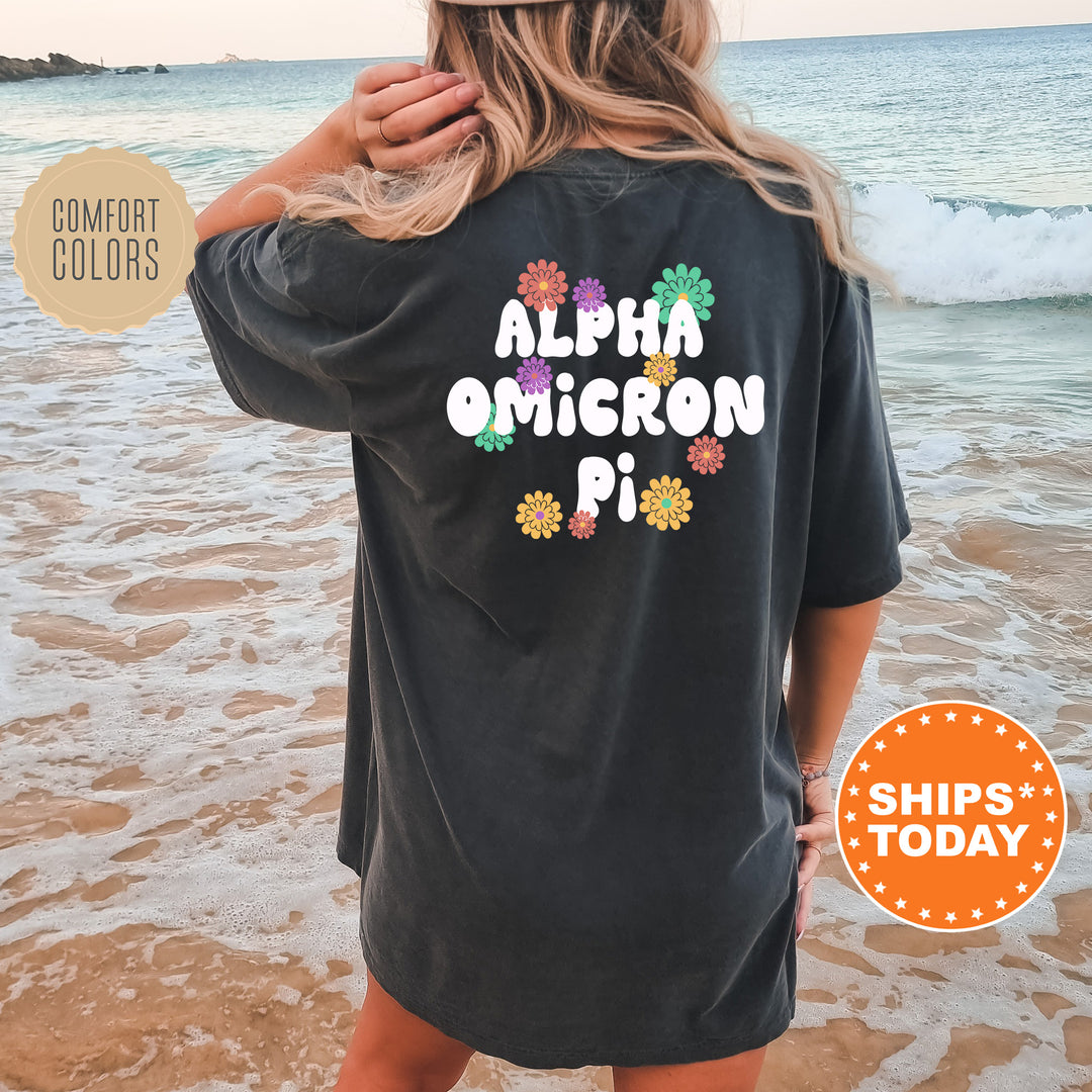 a woman standing on a beach wearing a black shirt