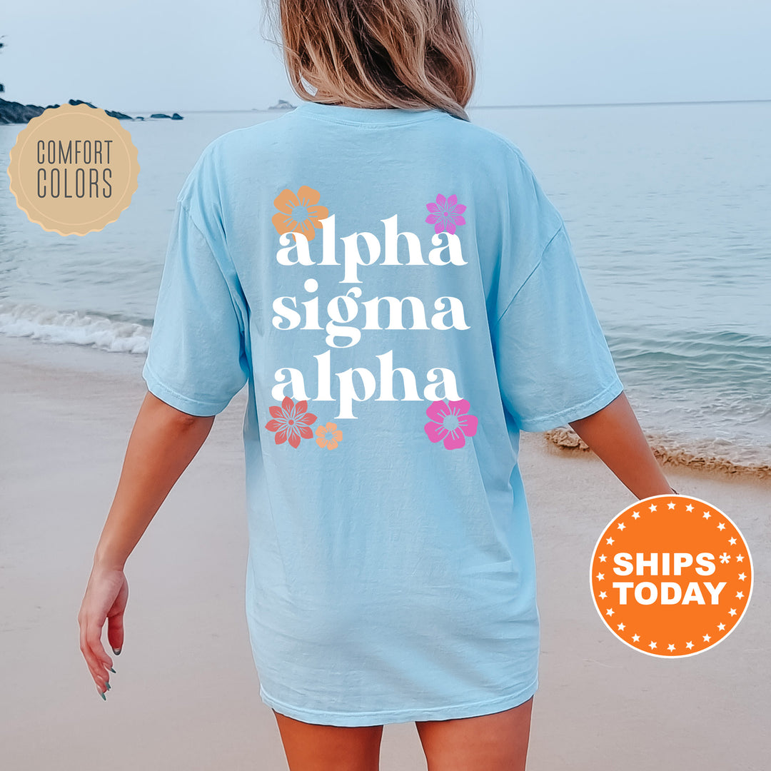 a woman walking on the beach wearing a blue shirt