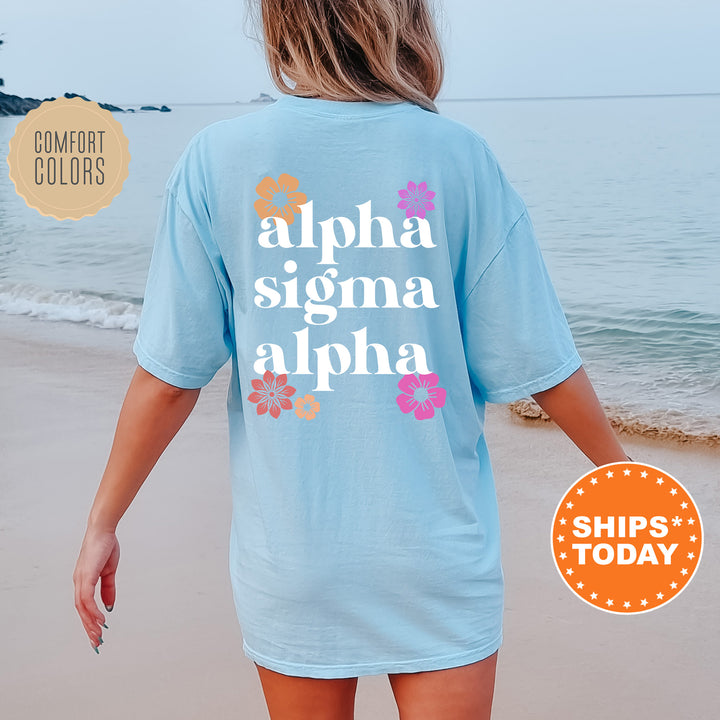 a woman walking on the beach wearing a blue shirt