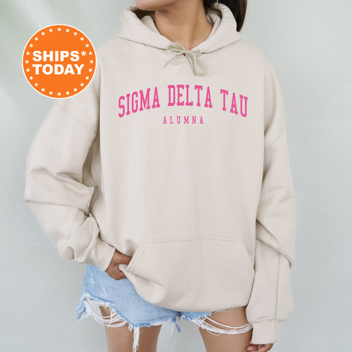 a woman wearing a sweatshirt that says stigma delta tau