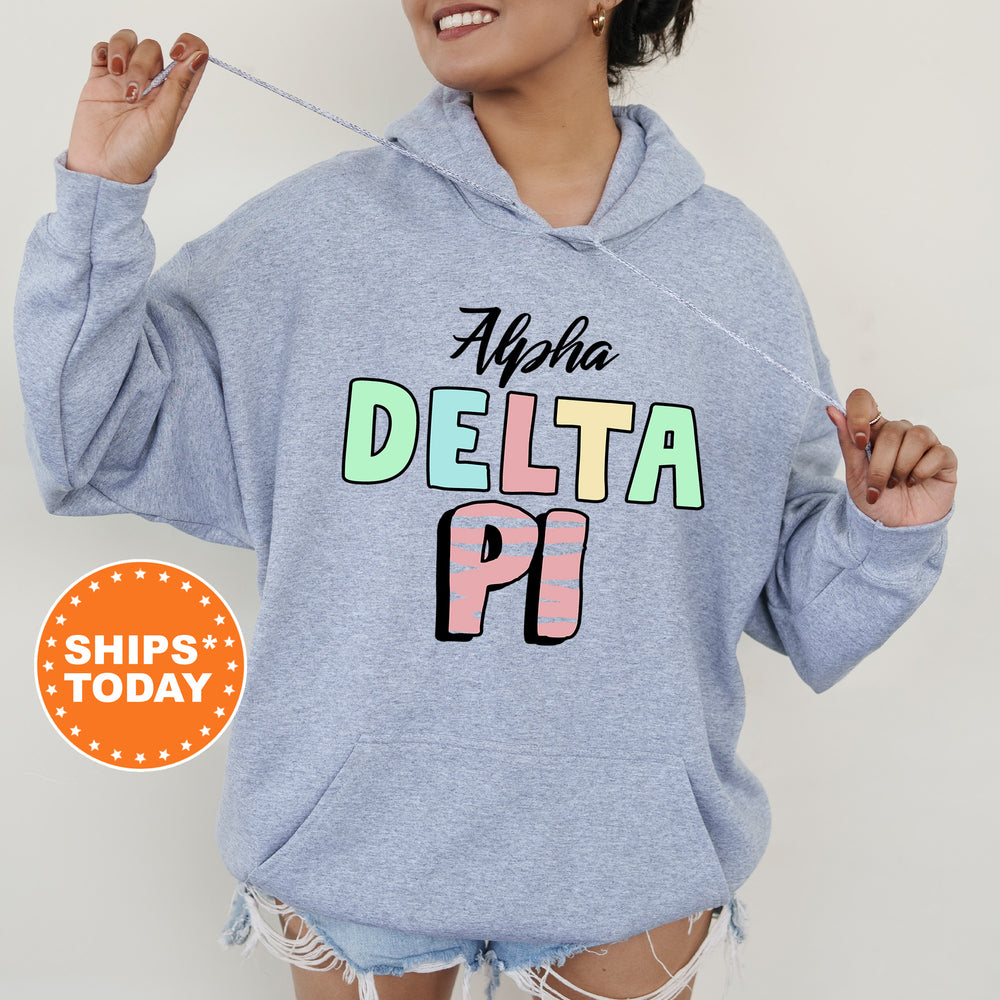 a woman wearing a sweatshirt with the words delta pi on it