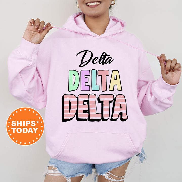 a woman wearing a pink delta delta hoodie